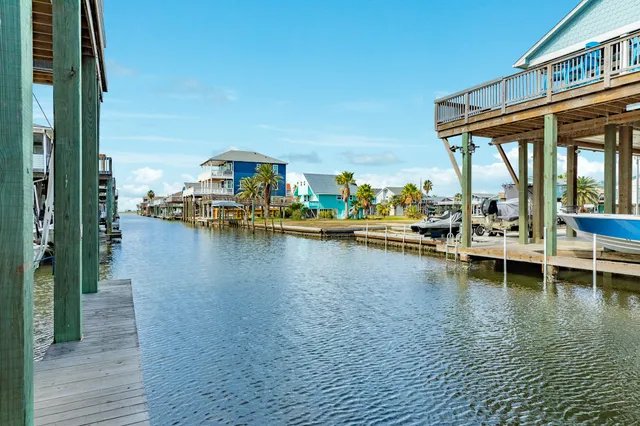 a view of a lake with boats in front of house