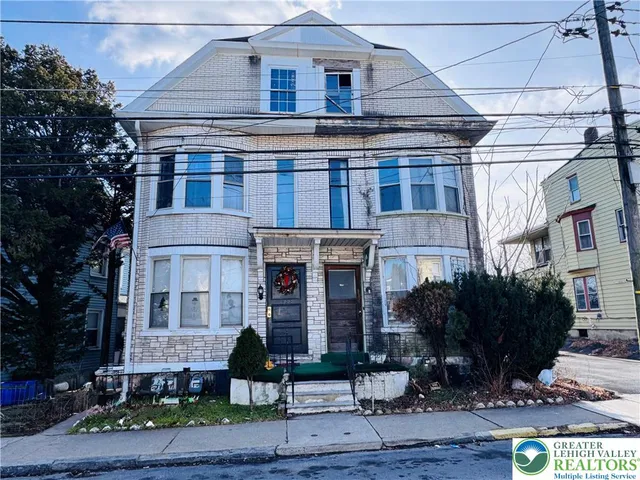a front view of a building with garden