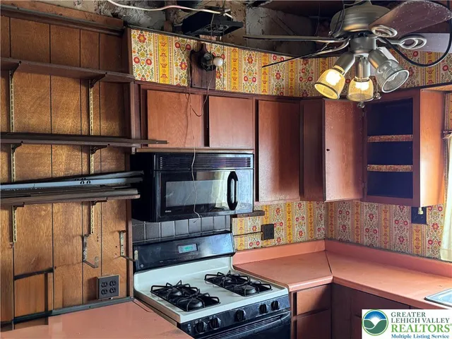 a kitchen with stainless steel appliances granite countertop a stove and a sink