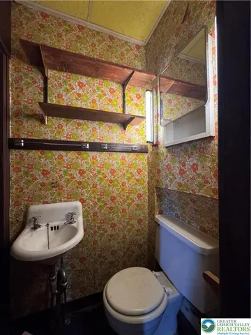 a bathroom with a toilet a sink and a window
