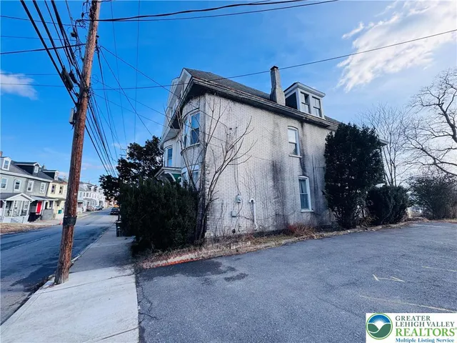 a building with potted plants in front of it