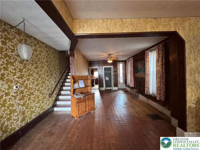 a view of a living room and entryway with wooden floor
