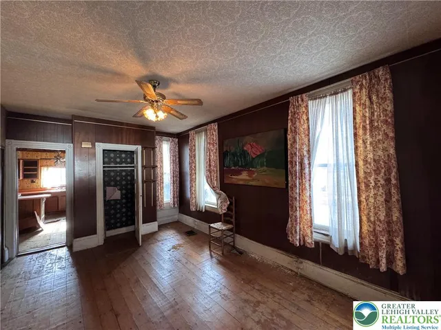 a view of a livingroom with furniture and a window
