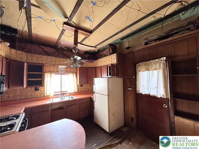 a kitchen with refrigerator and window