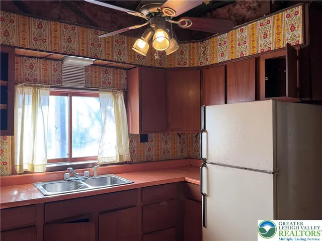 a kitchen with a refrigerator and a sink