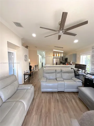 a bedroom with a large bed a flat tv screen and dresser