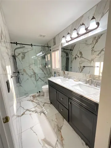 a view of a bathroom with wooden floor