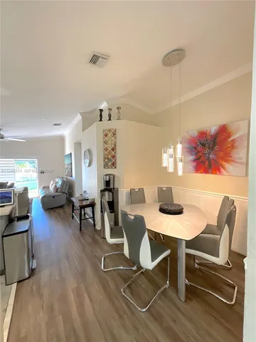 a large kitchen with a large window a sink and stainless steel appliances