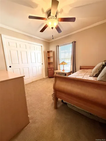 a bedroom with a bed dresser and a window