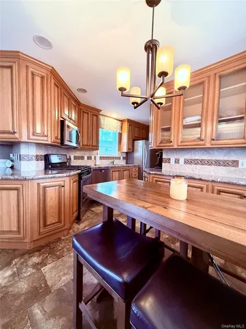 a kitchen with a sink appliances and cabinets