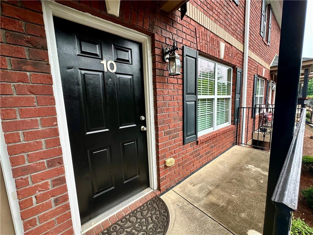 105 Whitehead Road, Unit 10 Athens, GA 30606 - Photo 2 of 16 a view of a brick house with a door and a large window