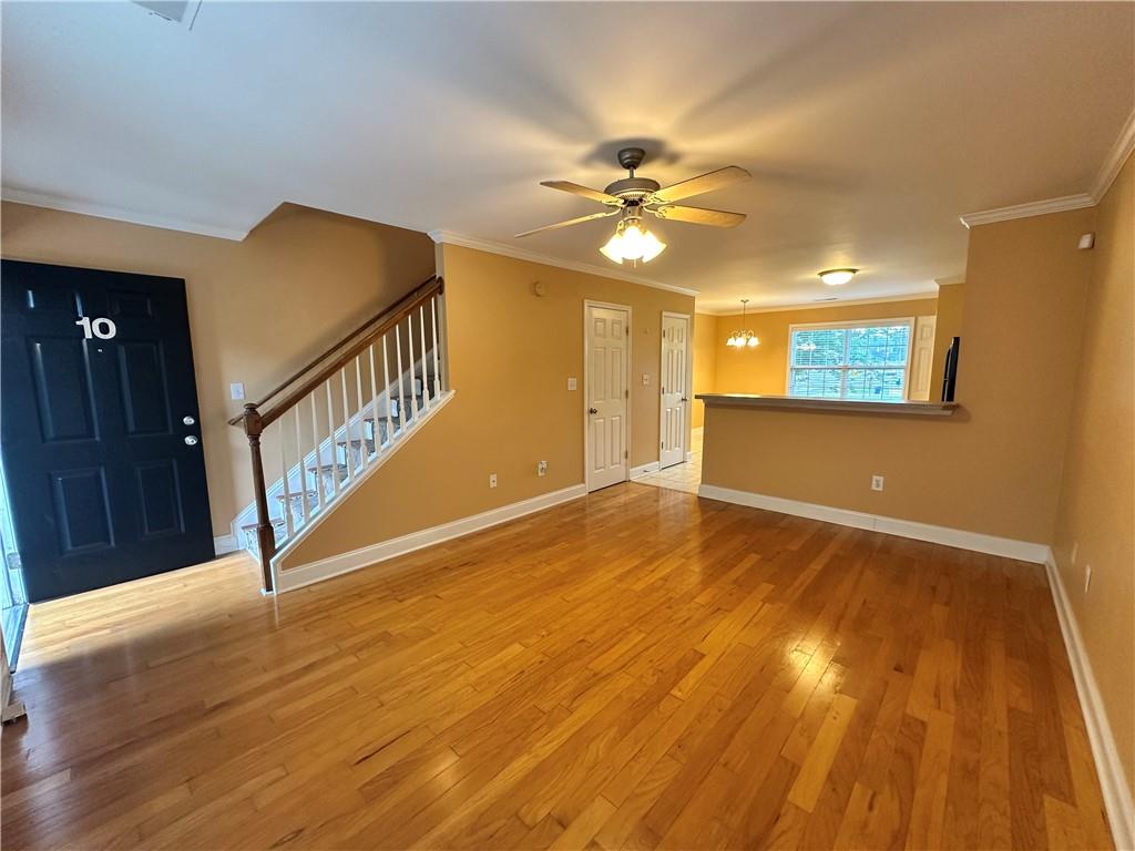 105 Whitehead Road, Unit 10 Athens, GA 30606 - Photo 4 of 16 a view of an empty room with wooden floor and a chandelier fan