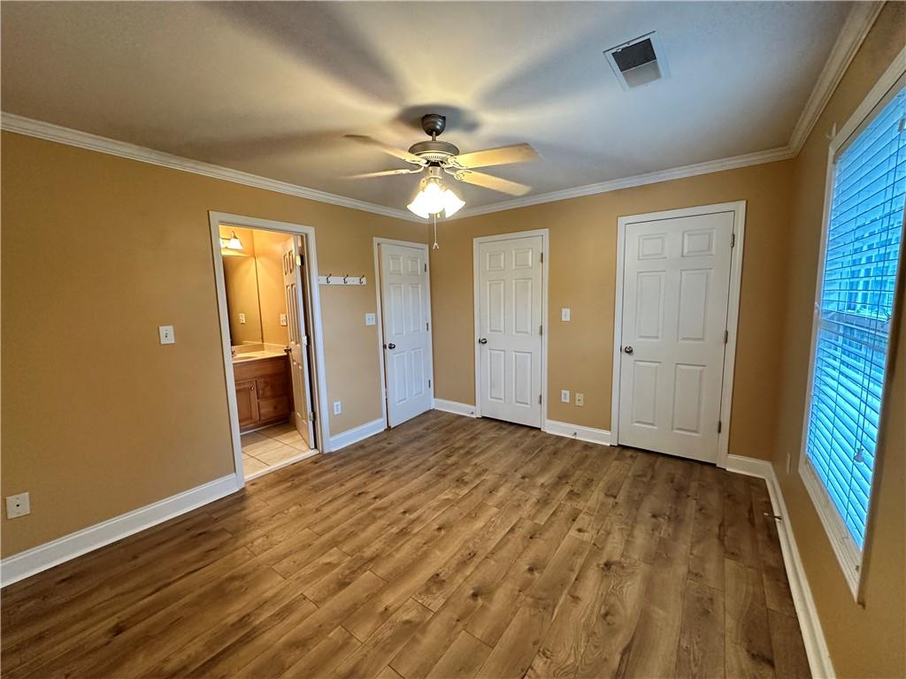 105 Whitehead Road, Unit 10 Athens, GA 30606 - Photo 8 of 16 wooden floor in an empty room with a window
