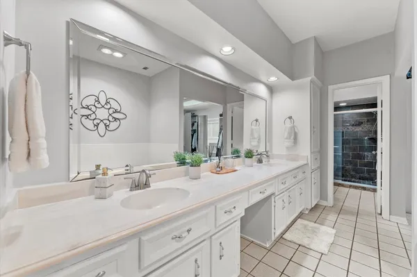 a spacious bathroom with a granite countertop sink mirror and