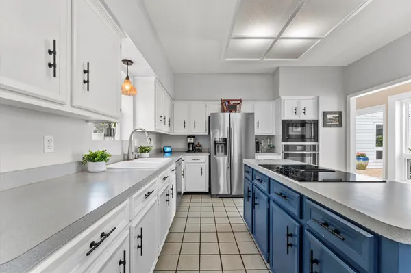 a kitchen with refrigerator and cabinets