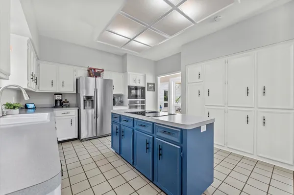 a kitchen with refrigerator cabinets and a sink