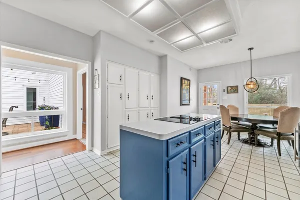 a kitchen with a sink and chairs