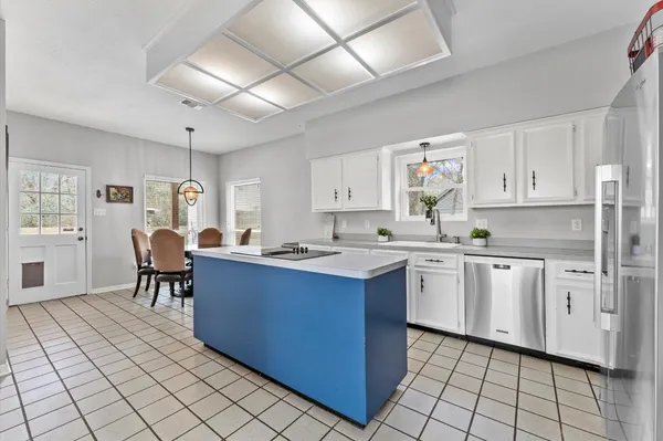 a open kitchen with kitchen island granite countertop a sink counter top space and cabinets