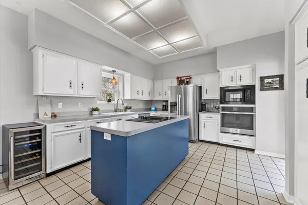 a kitchen with stainless steel appliances a stove sink and refrigerator