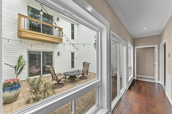 a view of a livingroom with a furniture wooden floor and chandelier