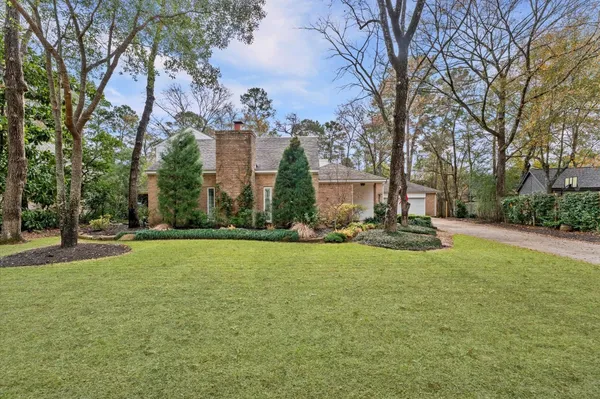 a view of a house with a yard and tree s
