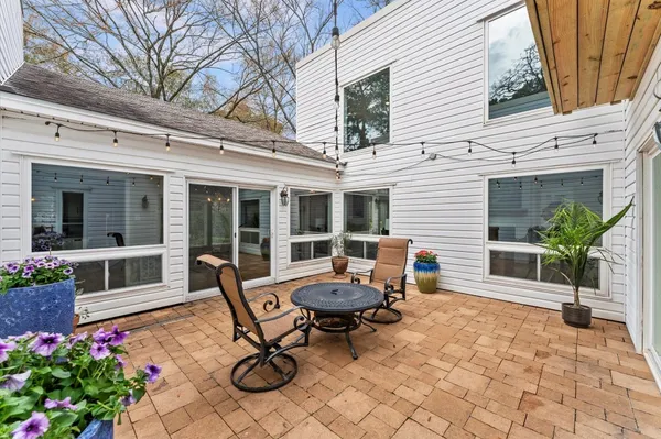 a backyard of a house with outdoor seating