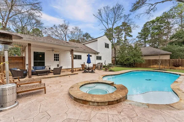 a swimming pool with outdoor seating