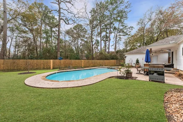 a view of a backyard with furniture and a fire pit