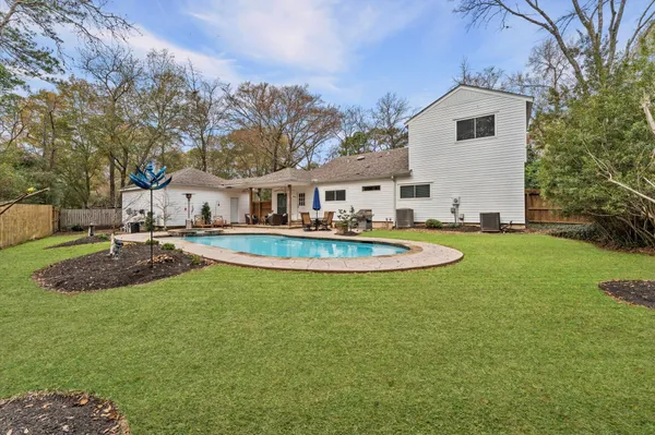 a view of a house with swimming pool and a yard
