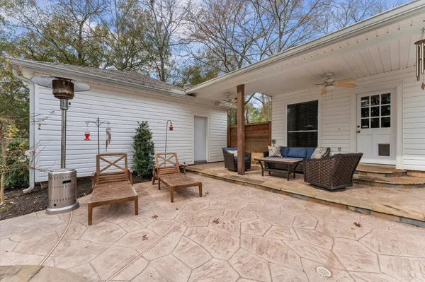 a building outdoor space with patio furniture and potted plants