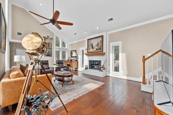 a living room with furniture a fireplace and a large window