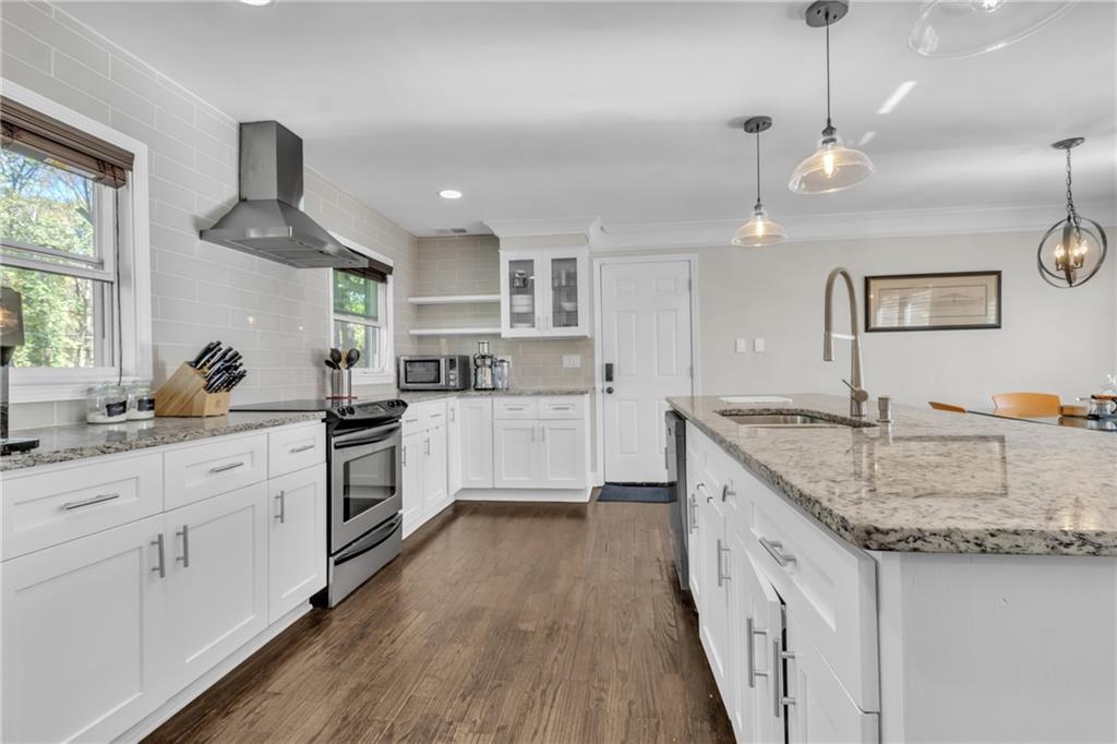 2363 Oakridge Court Decatur, GA 30032 - Photo 11 of 32 a kitchen with granite countertop a sink a counter space appliances and cabinets