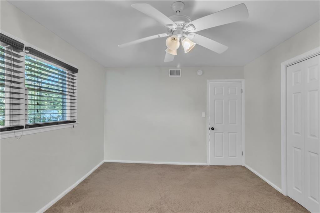 2363 Oakridge Court Decatur, GA 30032 - Photo 17 of 32 an empty room with a window and a fan