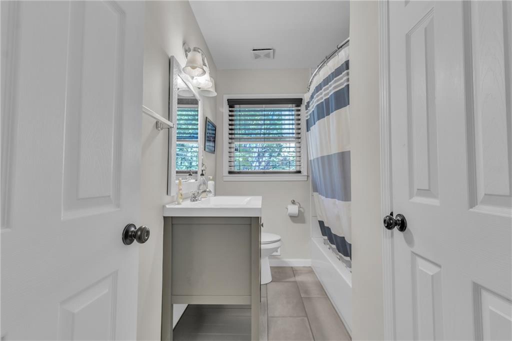 2363 Oakridge Court Decatur, GA 30032 - Photo 24 of 32 a bathroom with a tub sink and mirror