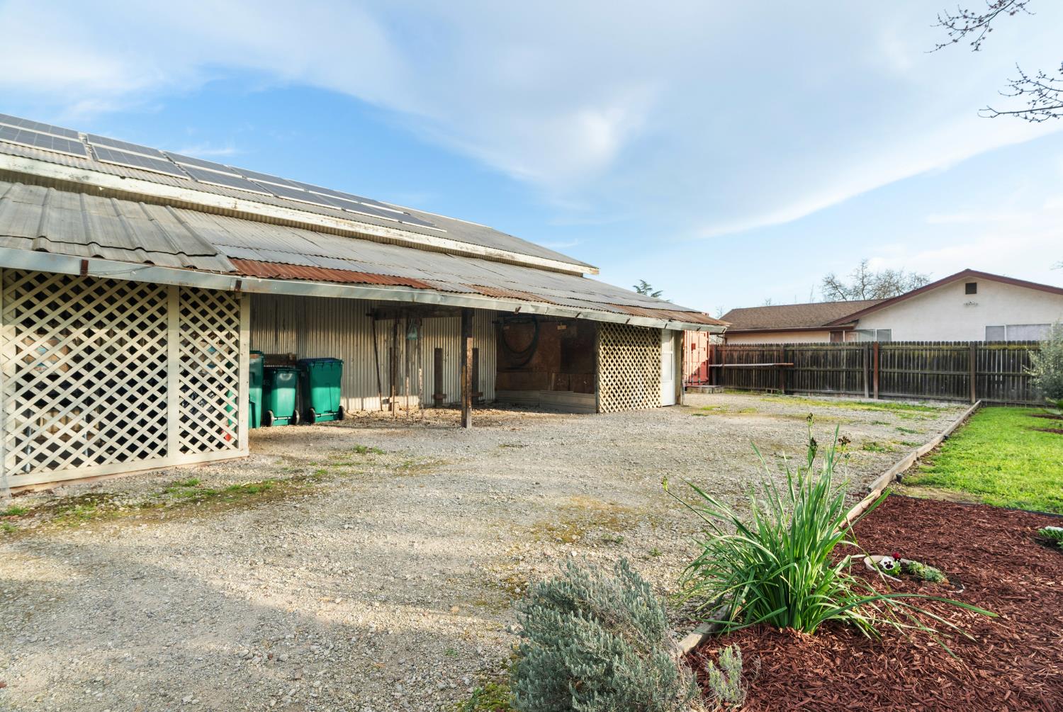 5610 North Confer Road Stockton, CA 95215 - Photo 12 of 40 Solar-powered Workshop, dedicated space. Solar panels shown on the roof. Landscaped lawn to the right.