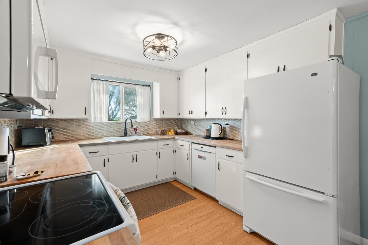 5610 North Confer Road Stockton, CA 95215 - Photo 10 of 40 Kitchen, side view, white cabinetry, main house