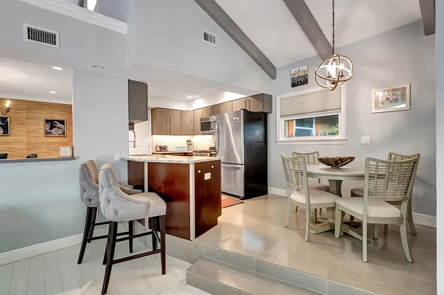 a view of a backyard with swimming pool and sitting area