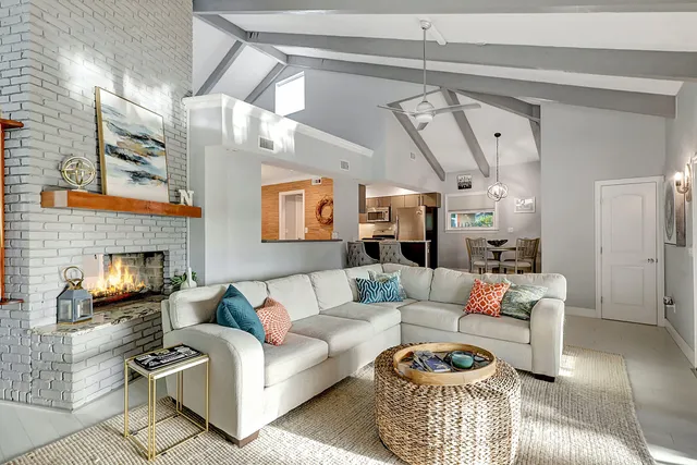 a view of a house with a big yard and palm trees