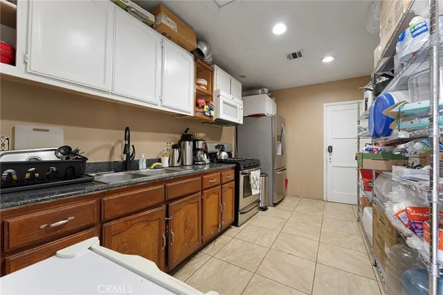 a kitchen with stainless steel appliances granite countertop a sink and cabinets