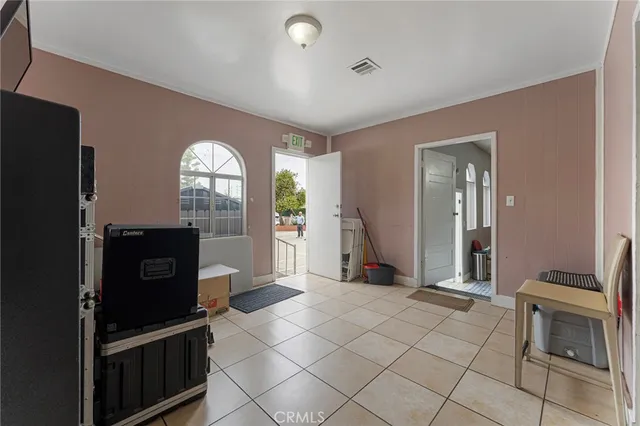 a view of a refrigerator in kitchen and windows