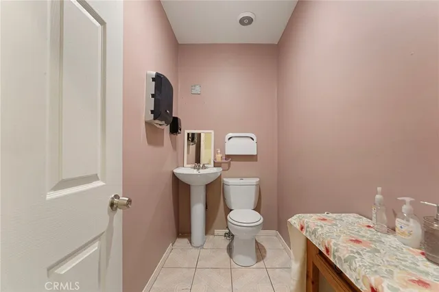 a bathroom with a granite countertop toilet and sink