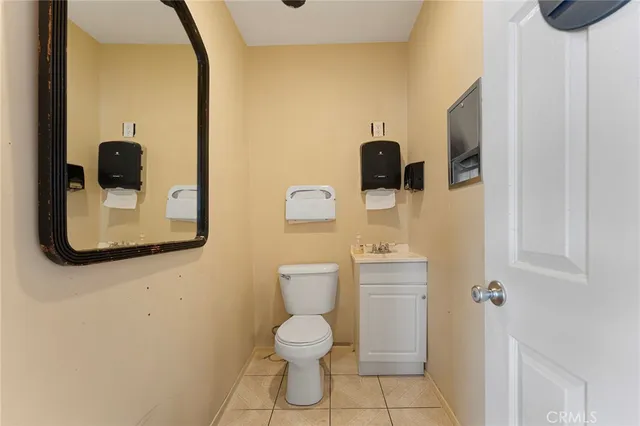 a bathroom with a toilet and a mirror