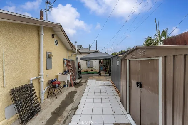 a view of a house with a yard and large tree