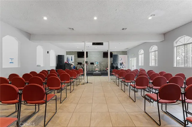 a living room with furniture and kitchen view