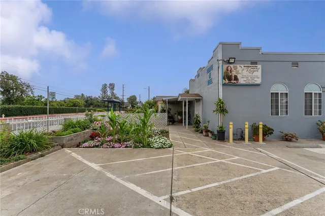 a view of a patio with couches and table and chairs and potted plants