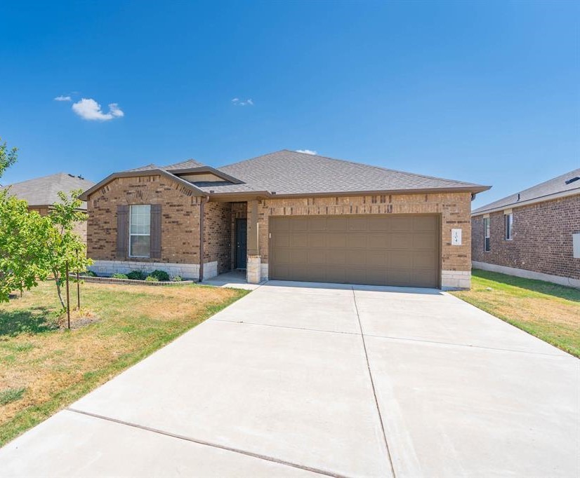 104 Sierra Mar Loop Leander, TX 78641 - Photo 1 of 1 a front view of a building with a garden
