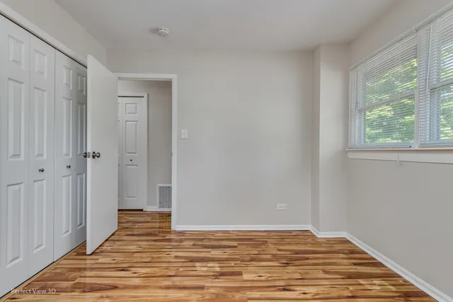 a view of a room with wooden floor and windows