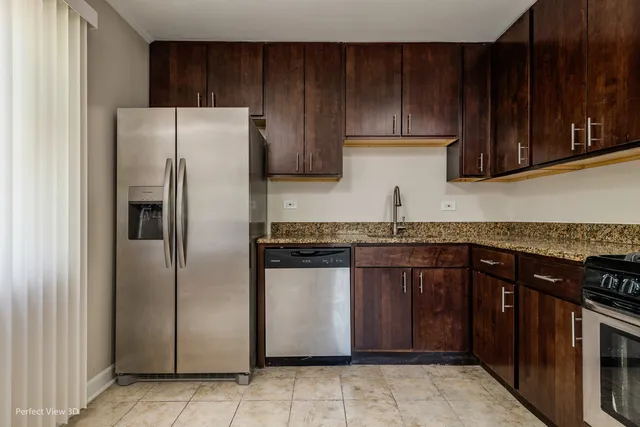 a kitchen with stainless steel appliances granite countertop a refrigerator and a stove top oven