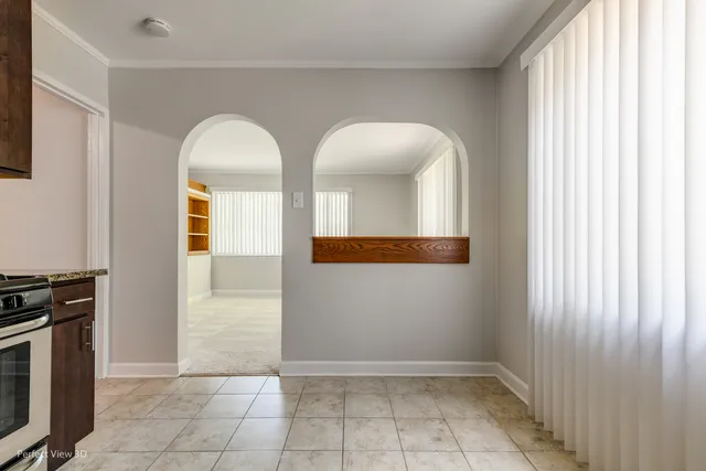 a view of a livingroom with wooden floor and a window