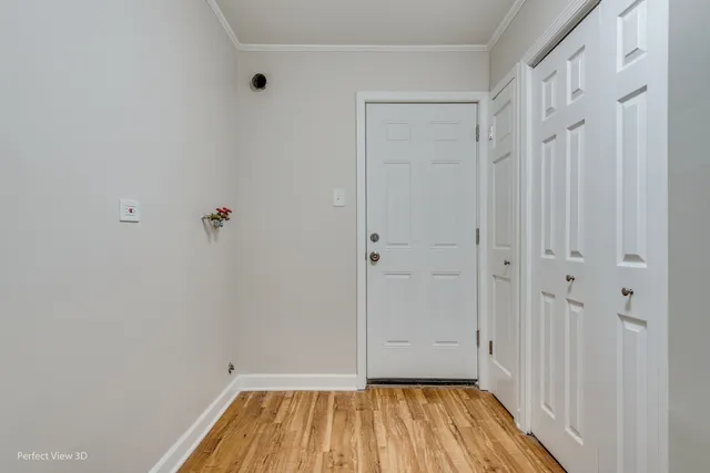 a view of a room with wooden floor